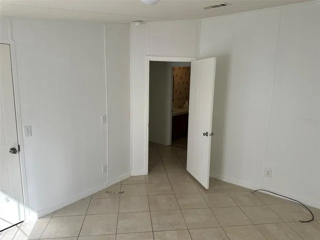 a view of an empty room and closet area