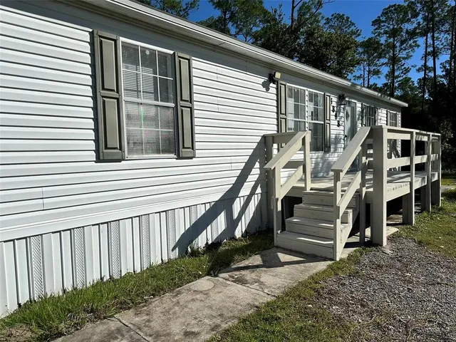 a view of a house with wooden fence