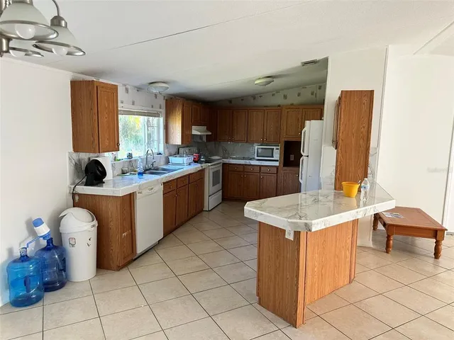 a kitchen with a sink appliances and cabinets