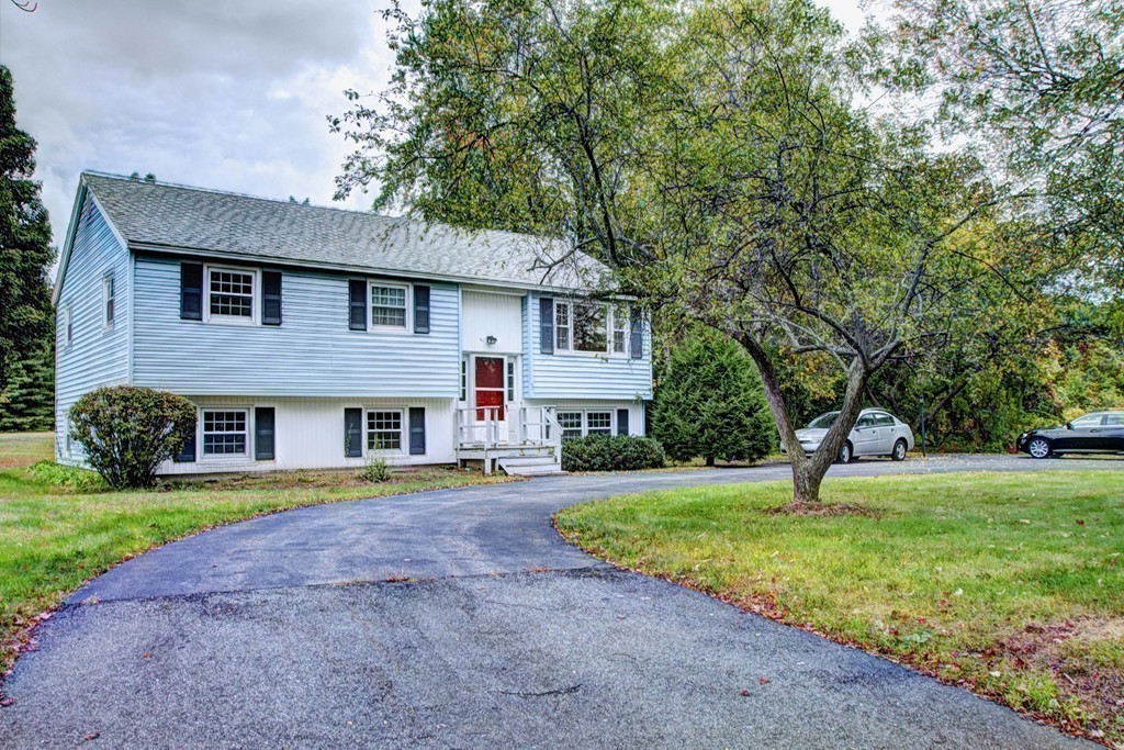 12 Mill Road Chelmsford, MA 01824 - Photo 11 of 11 a front view of a house with a yard