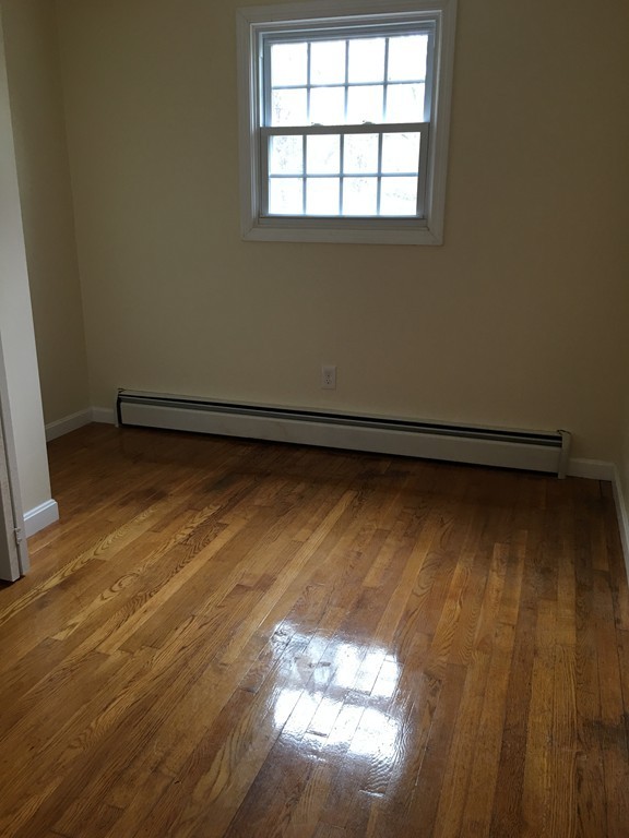 12 Mill Road Chelmsford, MA 01824 - Photo 4 of 11 a view of a room with wooden floor and a window