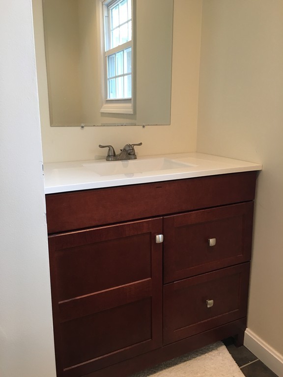 12 Mill Road Chelmsford, MA 01824 - Photo 6 of 11 a bathroom with a sink and a mirror