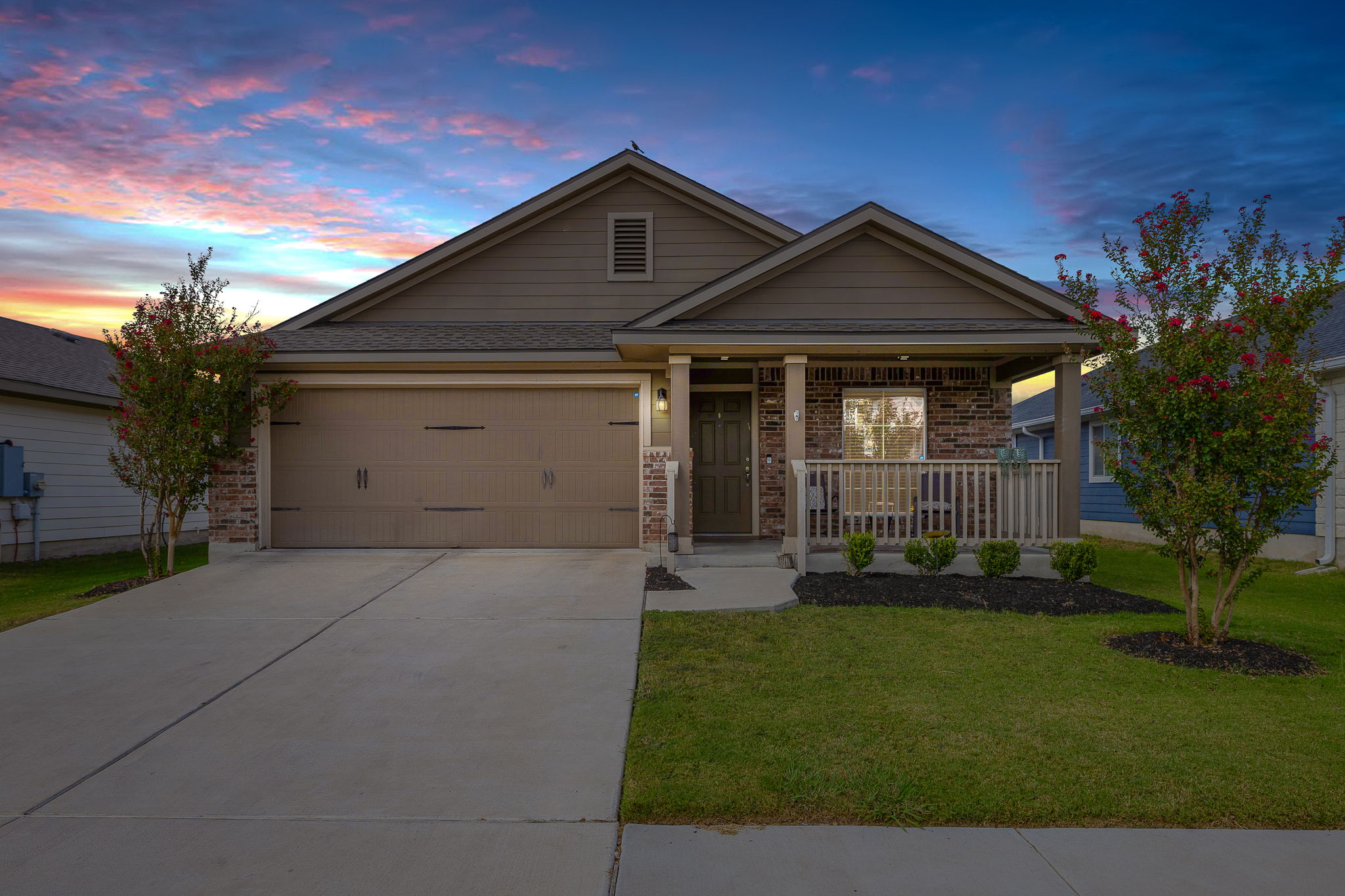 18400 Congaree Street Pflugerville, TX 78660 - Photo 1 of 1 Single story home with covered porch, brick siding, concrete driveway, a front lawn, and an attached garage