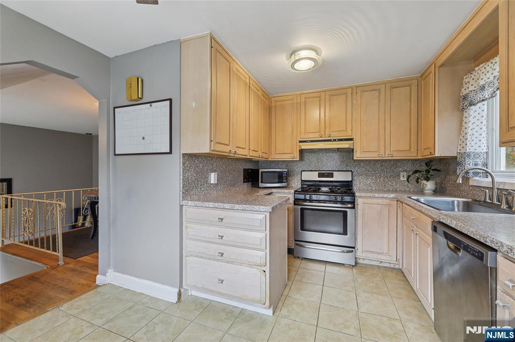 407 Semino Road Northvale, NJ 07647 - Photo 11 of 23 a kitchen with cabinets appliances and a window
