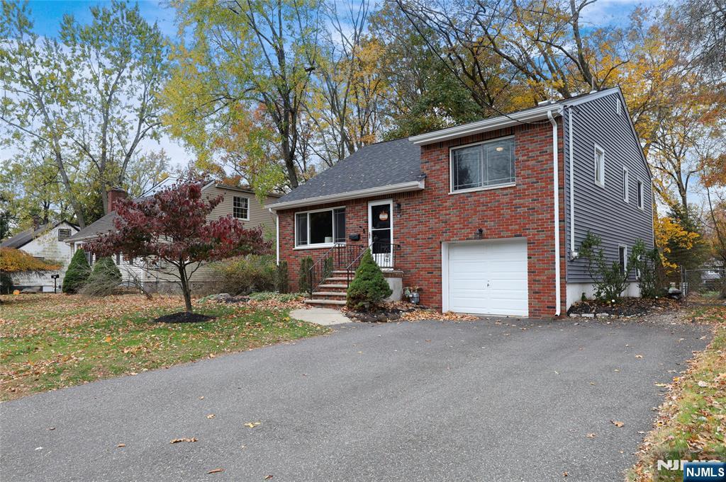 407 Semino Road Northvale, NJ 07647 - Photo 3 of 23 a front view of a house with a yard and garage