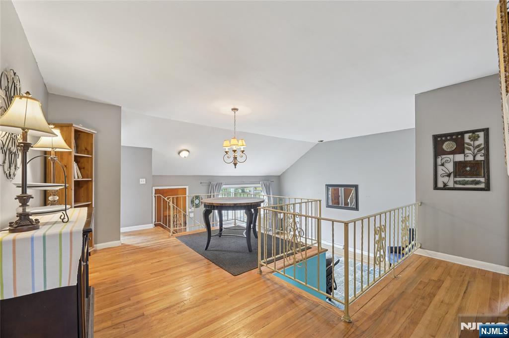 407 Semino Road Northvale, NJ 07647 - Photo 8 of 23 a view of a hallway with wooden floor and dining room