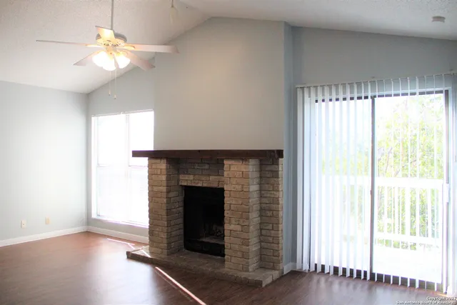a living room with a fireplace and a chandelier
