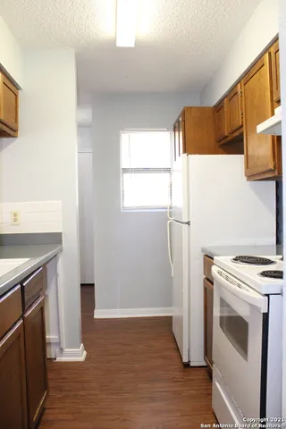a kitchen with a stove a refrigerator and a sink