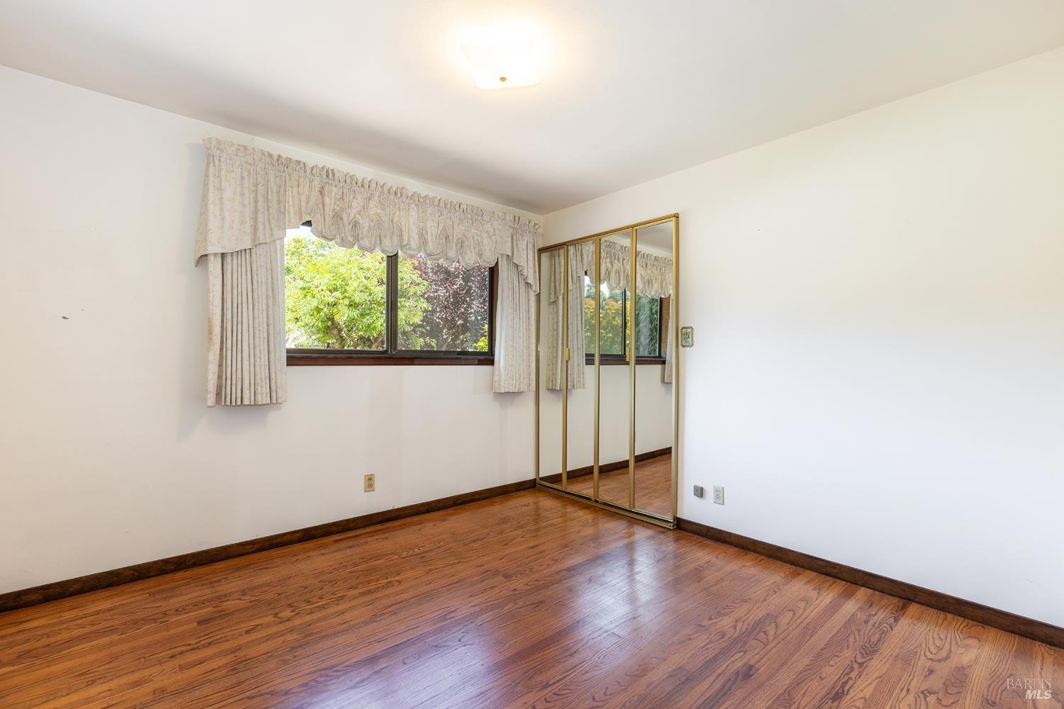 2236 West Hearn Avenue Santa Rosa, CA 95407 - Photo 25 of 56 an empty room with wooden floor and windows
