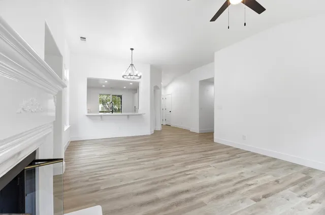 wooden floor in an empty room with a window