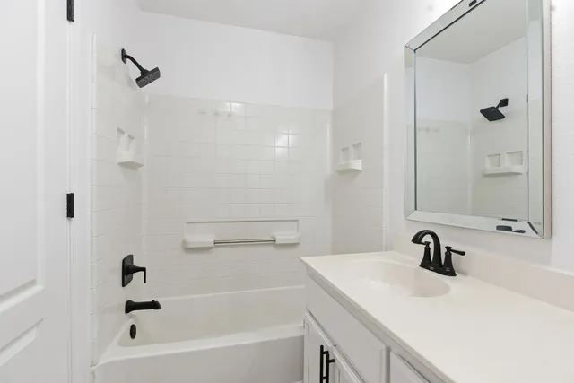 a bathroom with a sink a mirror and a bathtub