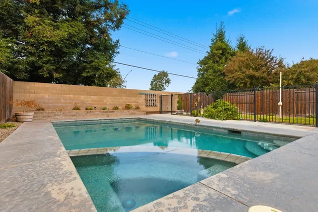 a view of a swimming pool with a yard