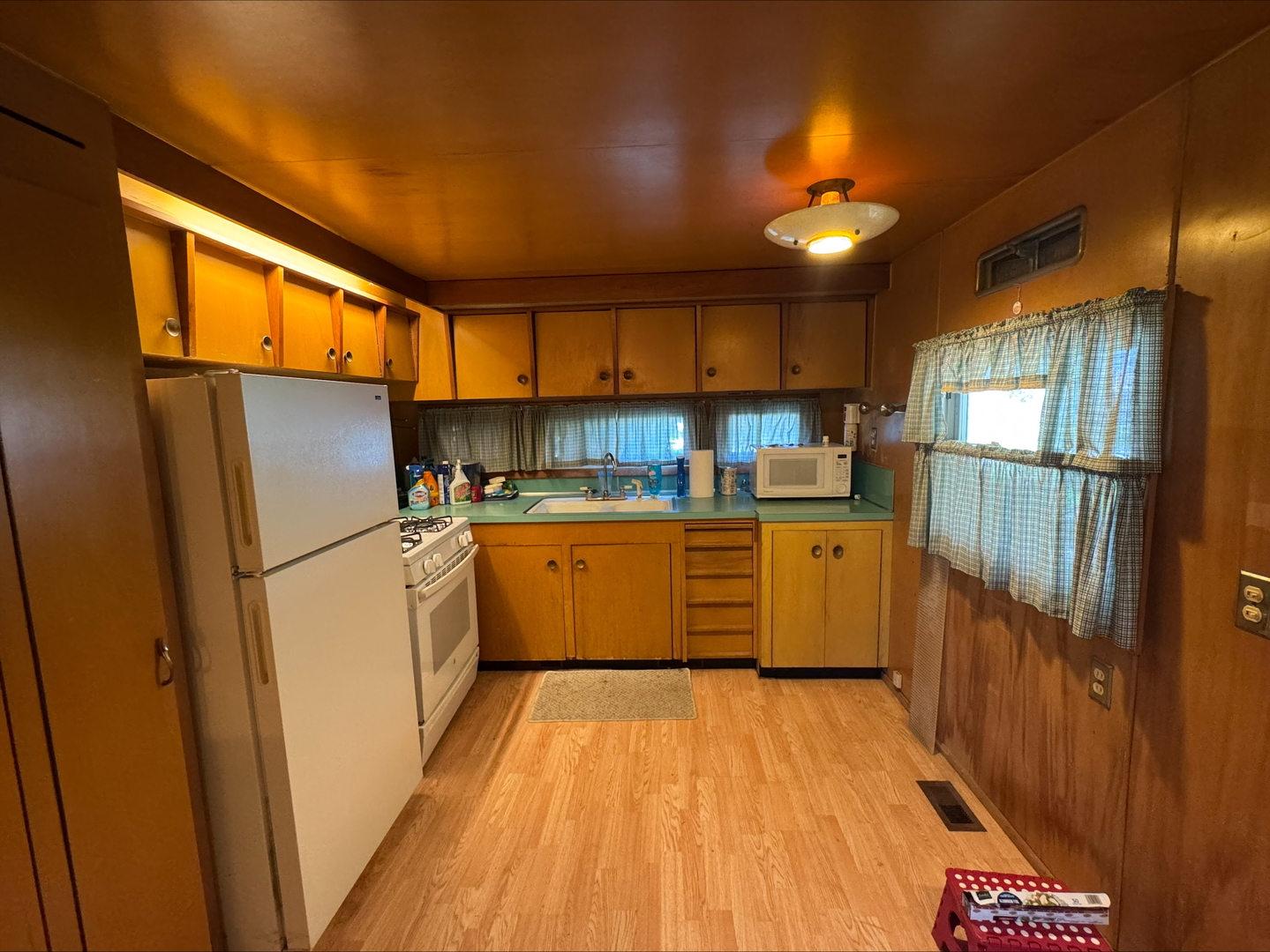 201 East Elm Street Chatsworth, IL 60921 - Photo 2 of 14 a kitchen with a refrigerator a sink and dishwasher with wooden floor
