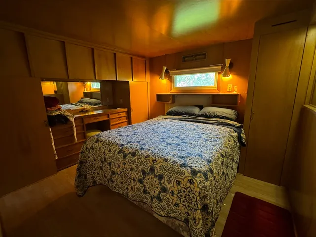 a bed sitting in a room next to a window