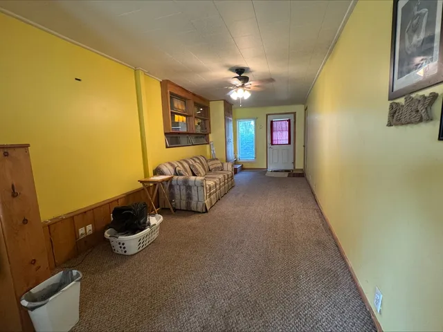 a view of a livingroom with furniture and windows