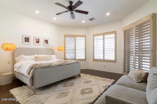 a bedroom with a bed and wooden floor