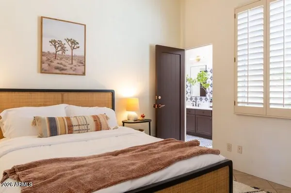 a bedroom with a bed and a window