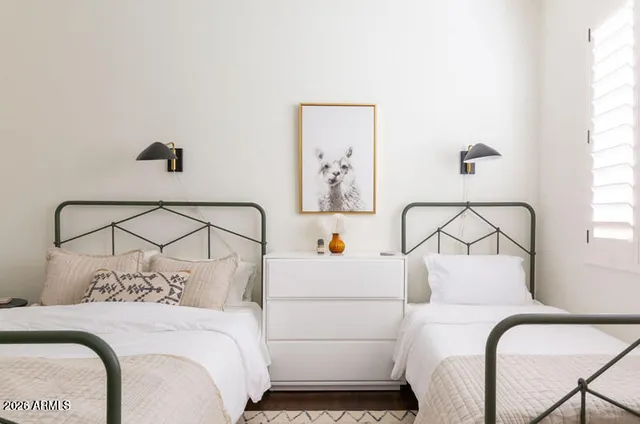a bedroom with a white bed and white chair