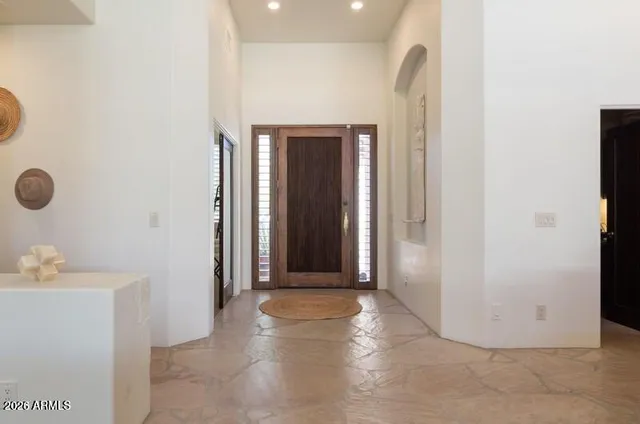 a view of a hallway to rooms