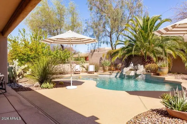 a swimming pool with outdoor seating and yard