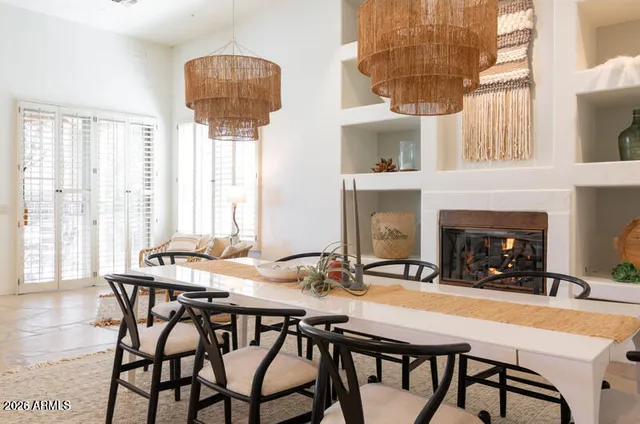 a view of a dining room with furniture and chandelier