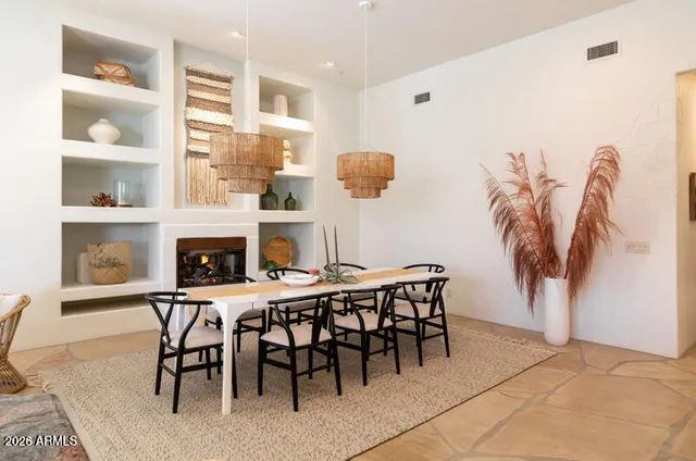a dining room with furniture and a fireplace