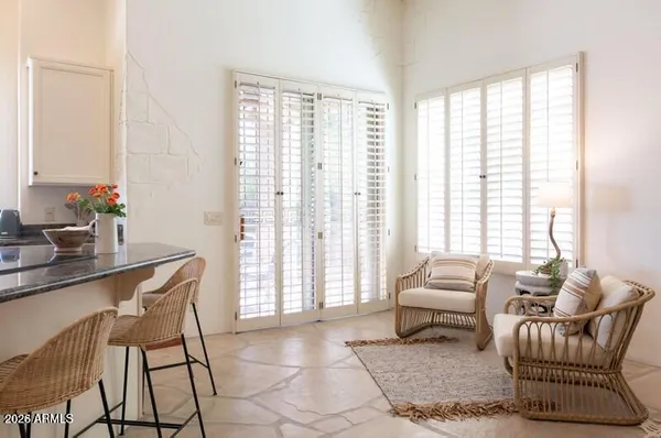 a living room with furniture and a floor to ceiling window