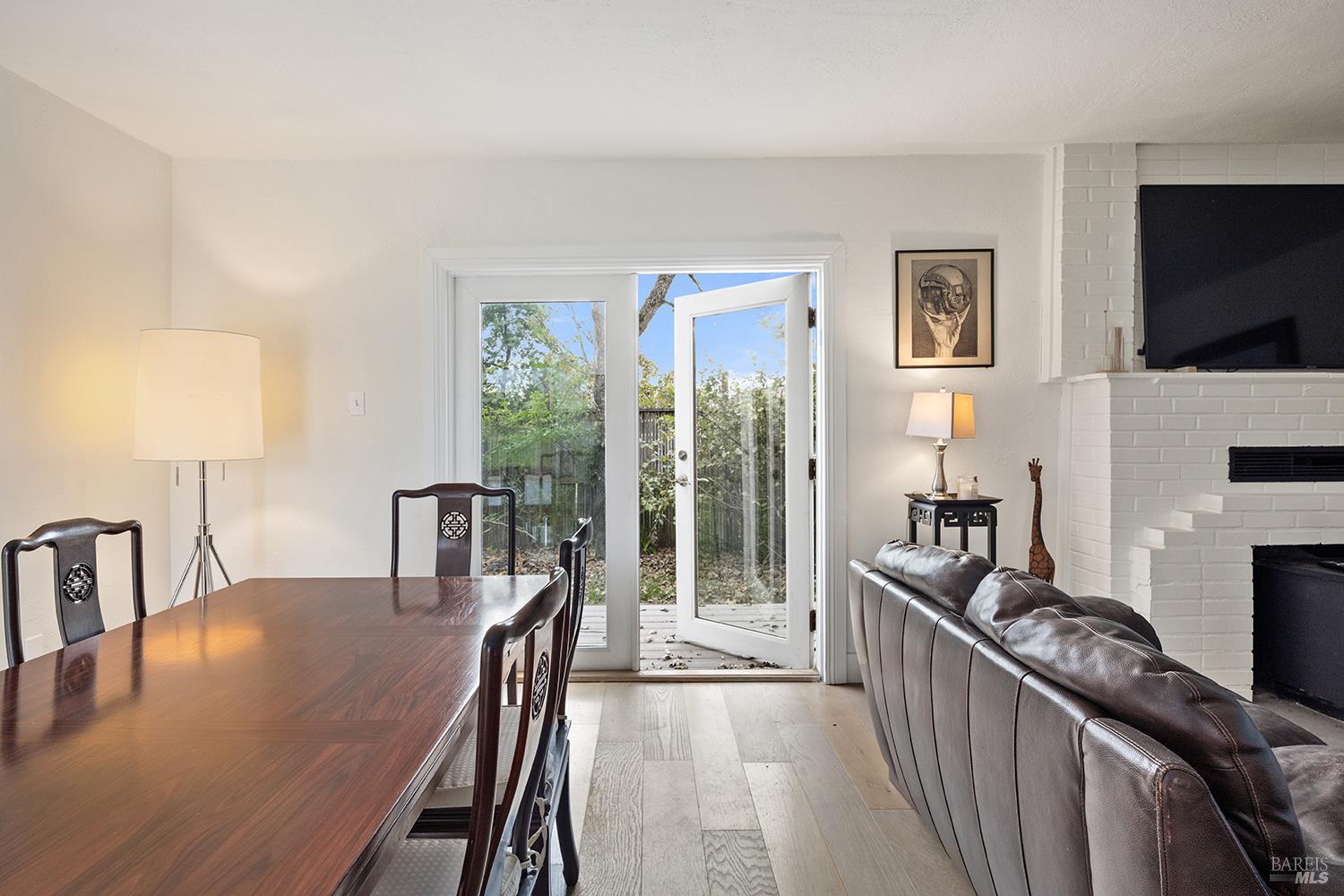 1979 Ludwig Avenue Santa Rosa, CA 95407 - Photo 13 of 52 a living room with furniture a flat screen tv and a floor to ceiling window