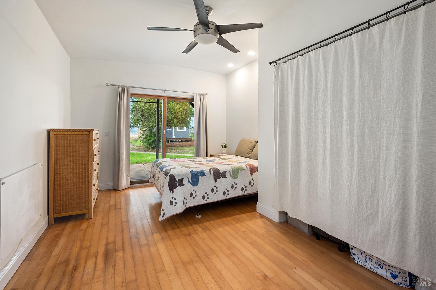 1979 Ludwig Avenue Santa Rosa, CA 95407 - Photo 30 of 52 a bedroom with a bed and wooden floor