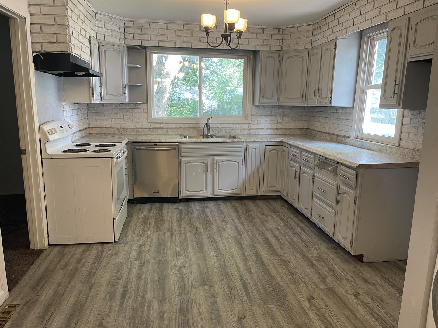 1824 16th Avenue Sterling, IL 61081 - Photo 11 of 26 a kitchen with a sink window and cabinets