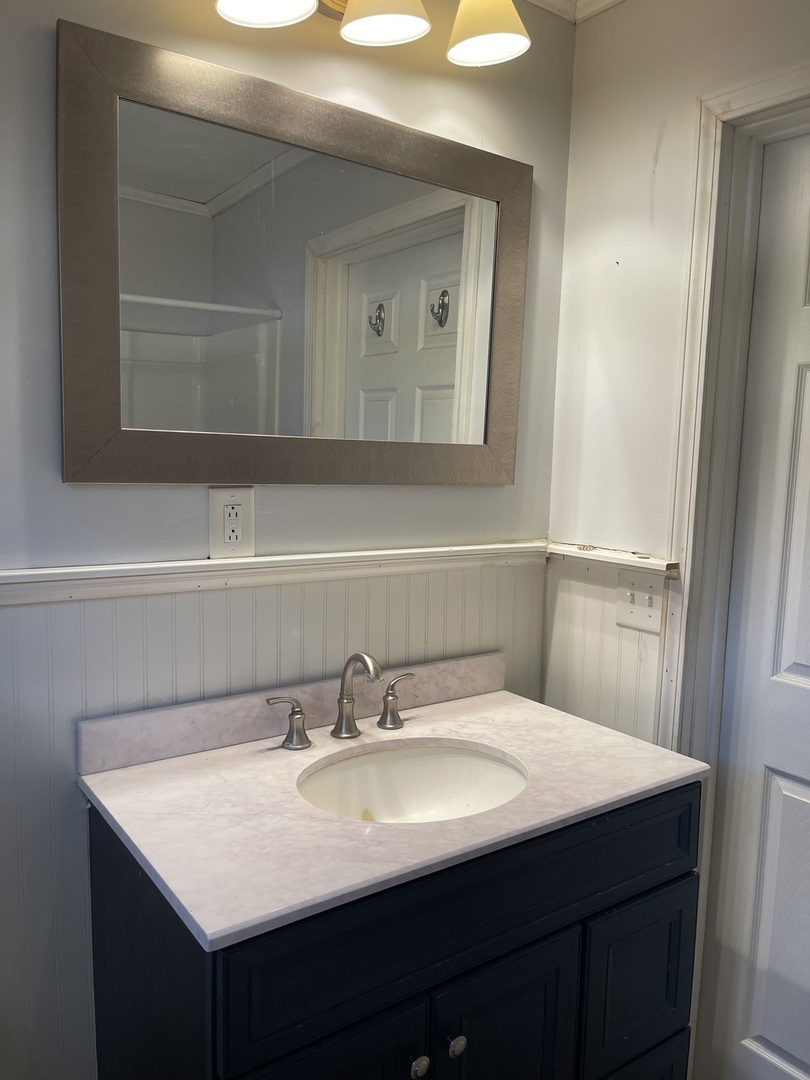 1824 16th Avenue Sterling, IL 61081 - Photo 15 of 26 a bathroom with a sink and a mirror