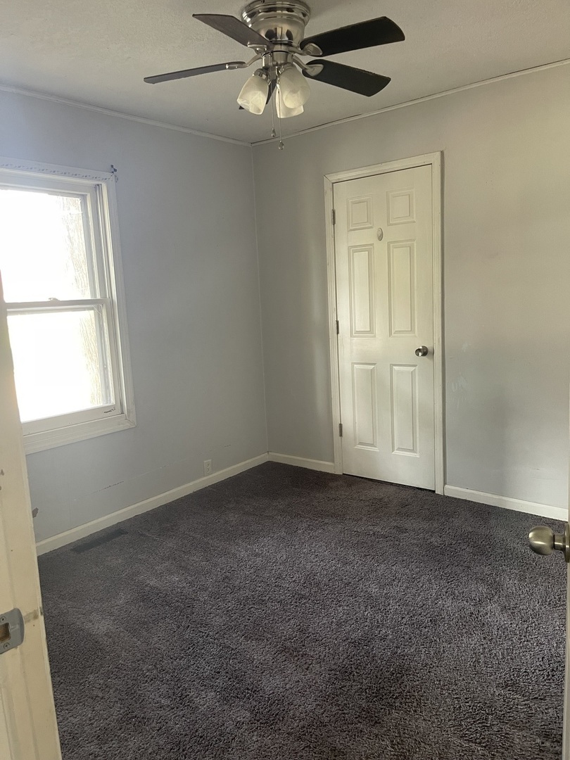 1824 16th Avenue Sterling, IL 61081 - Photo 18 of 26 an empty room with windows and fan