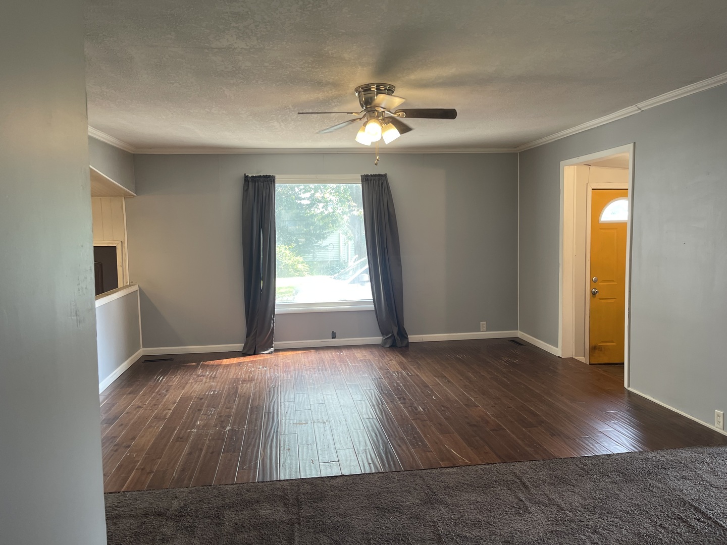 1824 16th Avenue Sterling, IL 61081 - Photo 9 of 26 a view of an empty room with wooden floor and a window