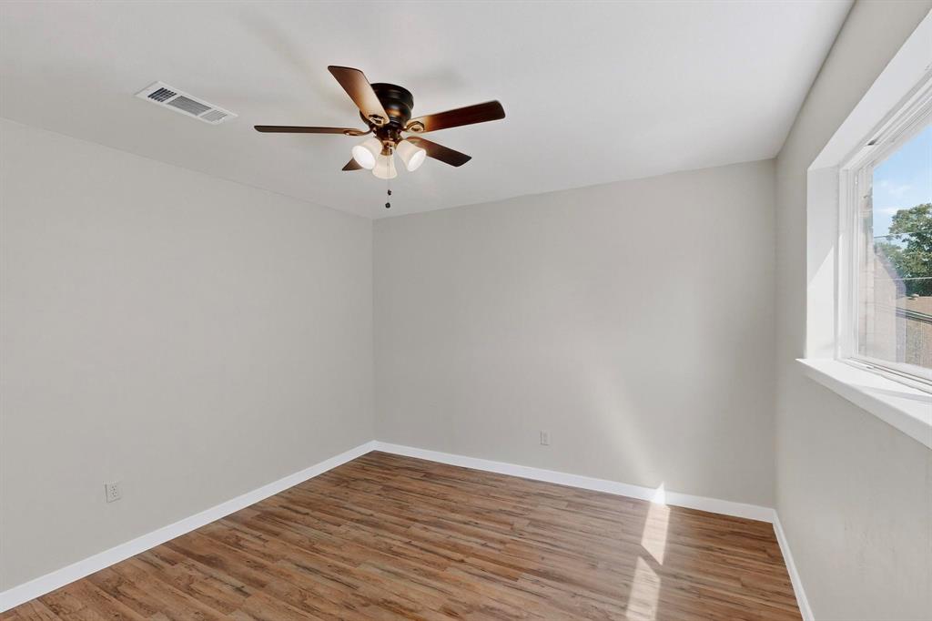 1407 El Camino Circle Princeton, TX 75407 - Photo 15 of 26 a view of an empty room with wooden floor and a window