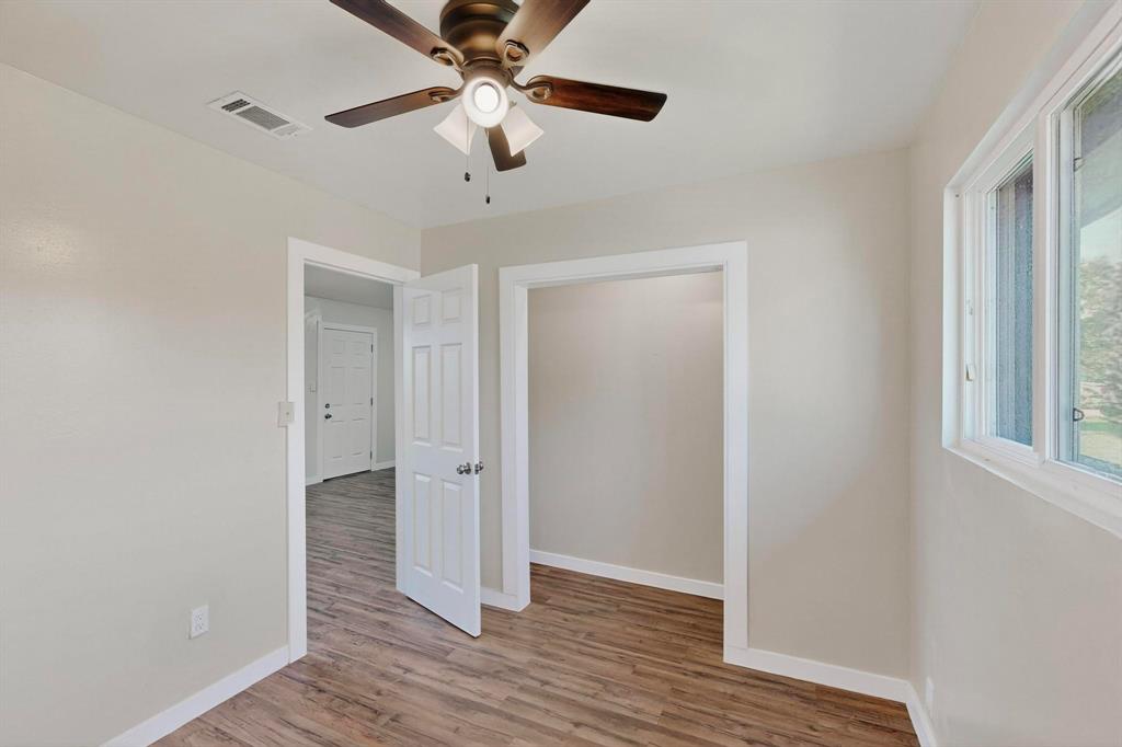 1407 El Camino Circle Princeton, TX 75407 - Photo 17 of 26 wooden floor in an empty room with a window