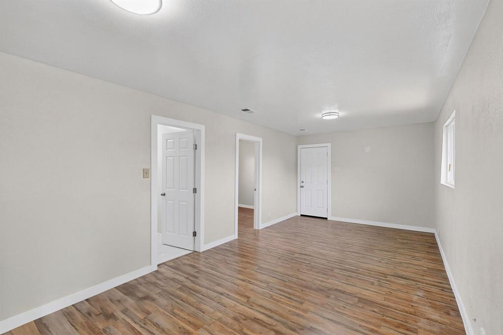 1407 El Camino Circle Princeton, TX 75407 - Photo 21 of 26 a view of an empty room with wooden floor