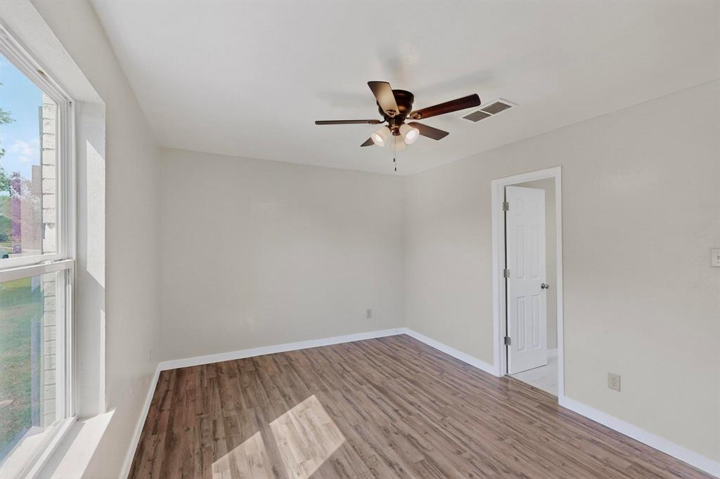 1407 El Camino Circle Princeton, TX 75407 - Photo 23 of 26 a view of empty room with wooden floor and fan
