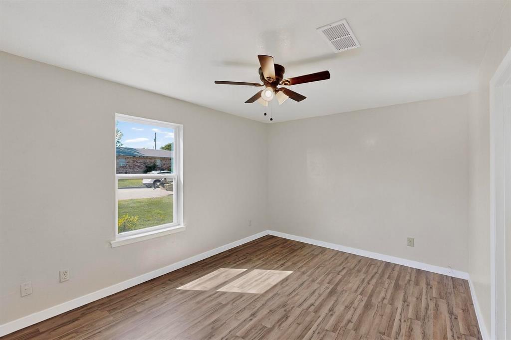 1407 El Camino Circle Princeton, TX 75407 - Photo 25 of 26 an empty room with a window and a ceiling fan
