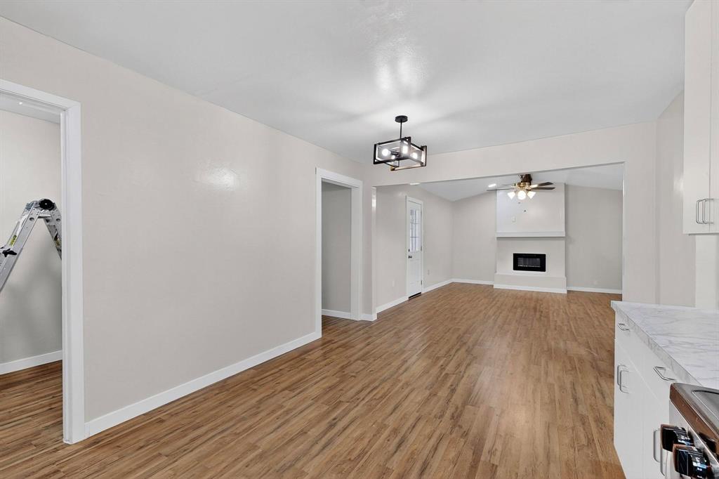 1407 El Camino Circle Princeton, TX 75407 - Photo 4 of 26 a view of empty room with wooden floor and fan