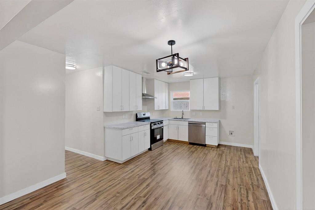 1407 El Camino Circle Princeton, TX 75407 - Photo 5 of 26 a kitchen with sink cabinets and wooden floor
