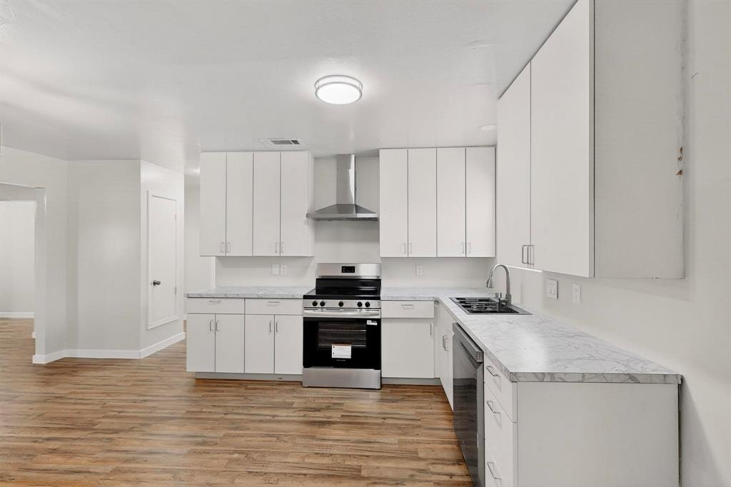 1407 El Camino Circle Princeton, TX 75407 - Photo 6 of 26 a kitchen with a sink stove top oven and cabinets