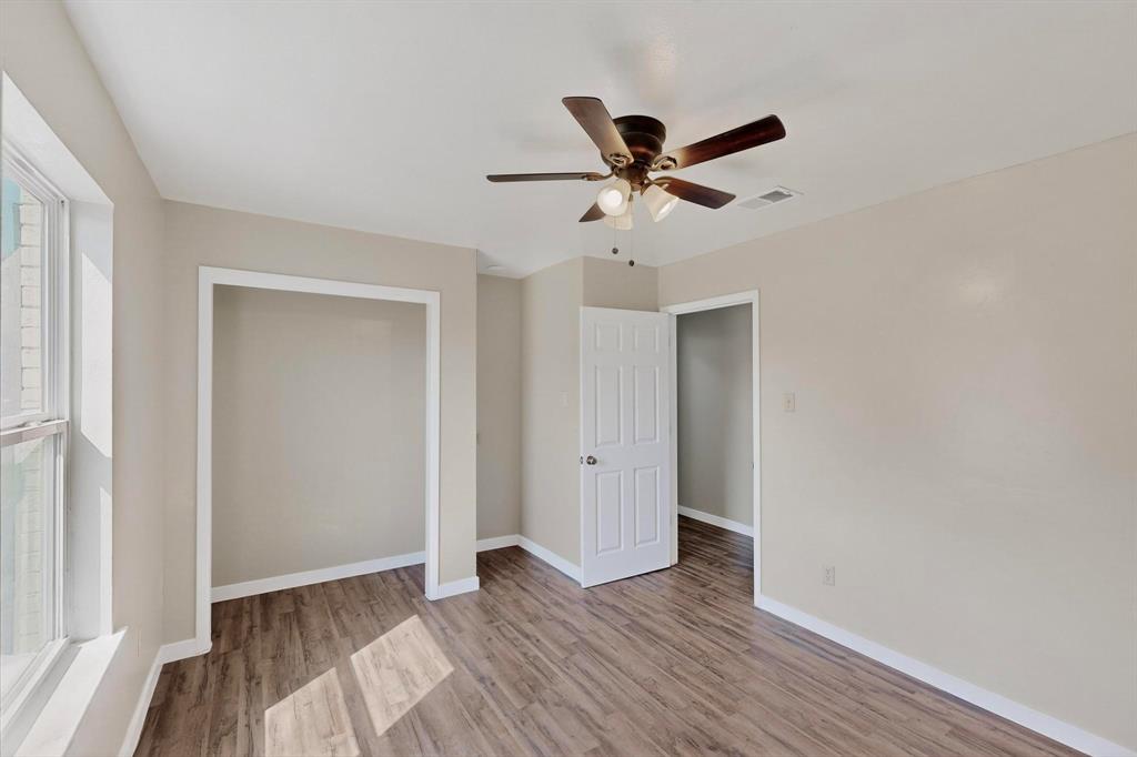 1407 El Camino Circle Princeton, TX 75407 - Photo 8 of 26 a view of an empty room with wooden floor and a window