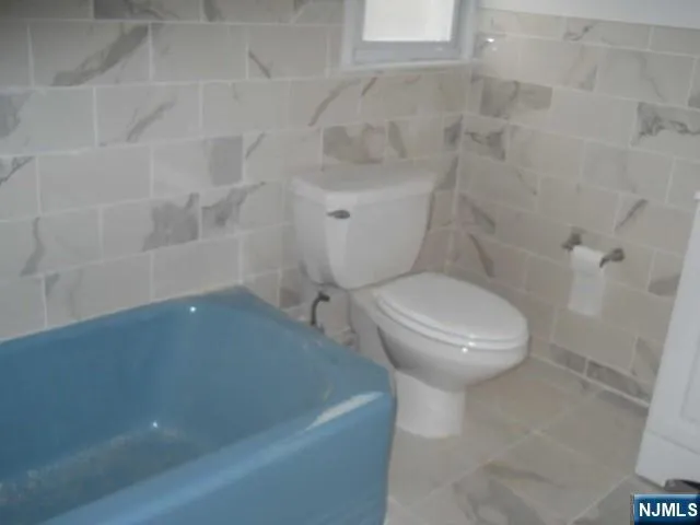 a white toilet sitting next to a white sink