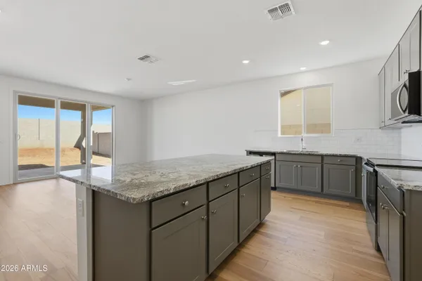 a kitchen with granite countertop a sink and a stove