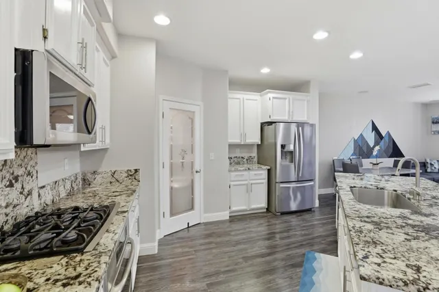 a kitchen with refrigerator and microwave