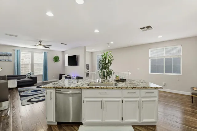 a kitchen with stainless steel appliances granite countertop a sink and cabinets