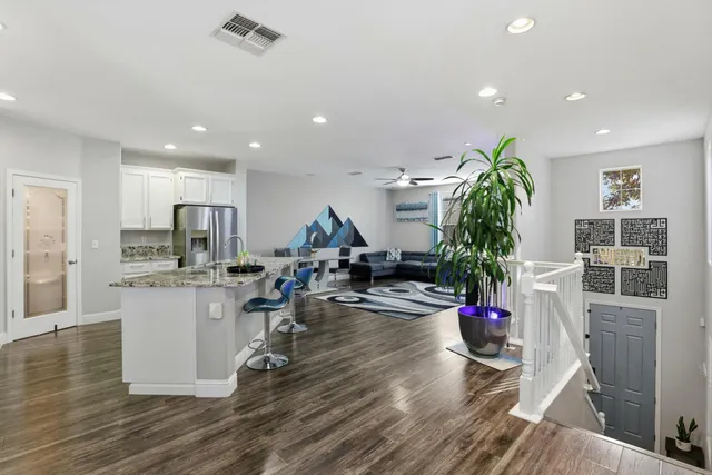 a living room with furniture and a potted plant