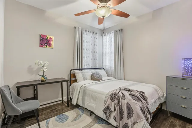 a bedroom with a bed and a chandelier