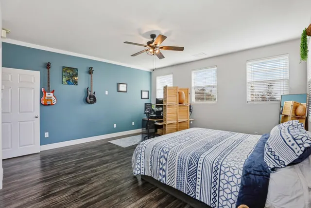 a bedroom with a bed and wooden floor