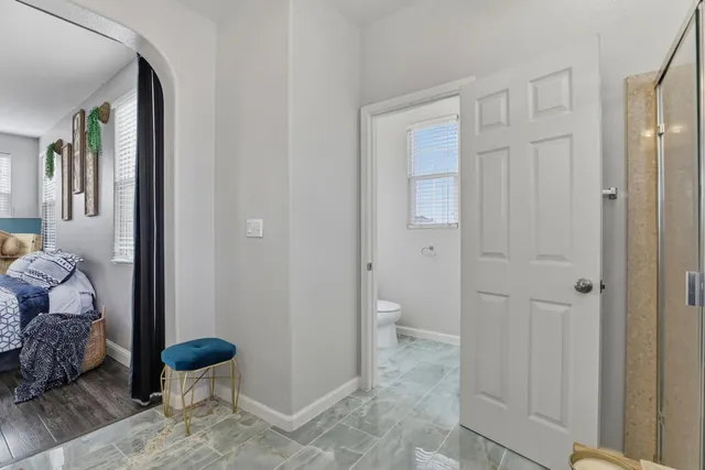 a bathroom with a toilet sink and shower